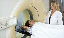 Patient in CT scanner with technologist